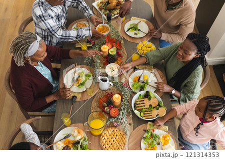African american parents, children and grandparents celebrating at thanksgiving dinner 121314353