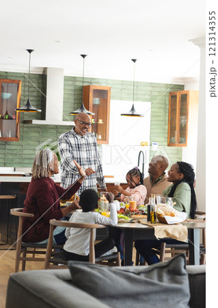 African american parents, children and grandparents celebrating at thanksgiving dinner 121314355