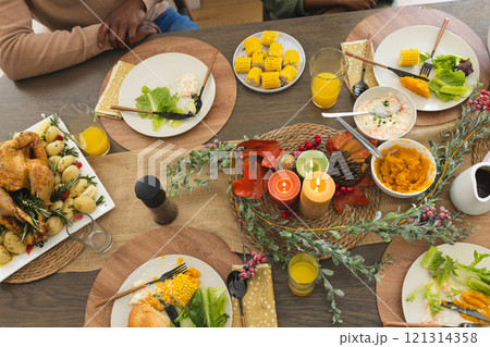 Thanksgiving dinner celebrating by african american parents, children and grandparents 121314358