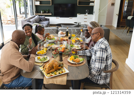African american parents, children and grandparents celebrating at thanksgiving dinner African american parents, children and grandparents celebrating at thanksgiving dinner 121314359