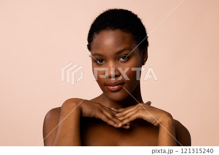 African american woman with short hair with hands under chin African american woman with short hair with hands under chin 121315240