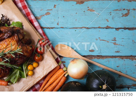 Cooked chicken and multiple food ingredients with copy space on blue wooden surface 121315750