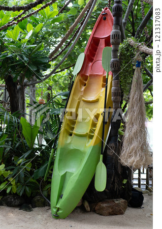 Colorful colorful canoe leaning against a tree on a tropical beach. Koh Phangan, Thailand , Asia. 121317083