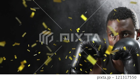 Image of confetti falling over african american male boxer on black background 121317550