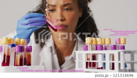 Holding test tube, scientist analyzing blood sample over programming code image 121318696