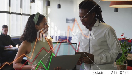 Analyzing financial graphs, business professionals discussing data over image of charts 121318759