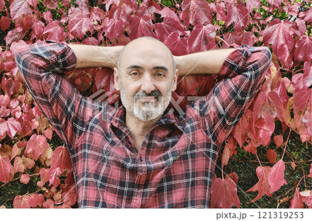 Man portrait in a checked shirt with an autumnal background Man portrait in a checked shirt with an autumnal background 121319253