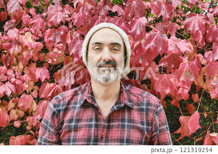 Man portrait in a checked shirt with an autumnal background 121319254