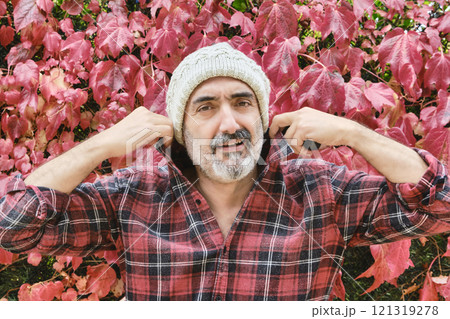 Man portrait in a checked shirt with an autumnal background Man portrait in a checked shirt with an autumnal background 121319278