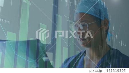 Image of financial data processing over asian male doctor holding x-ray scan Image of financial data processing over asian male doctor holding x-ray scan 121319395