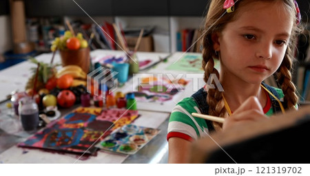 Cute schoolgirl painting on canvas in drawing class 4k 121319702