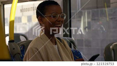 Happy female commuter having coffee while using mobile phone in bus 4k 121319753
