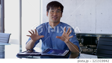 Front view of Asian male executive interacting in the office Front view of Asian male executive interacting in the office 121319942
