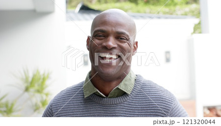 Portrait of african american man on garden terrace smiling and laughing Portrait of african american man on garden terrace smiling and laughing 121320044