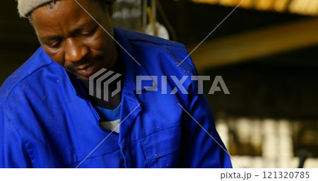 Worker putting soil in wooden mold in workshop Worker putting soil in wooden mold in workshop 121320785