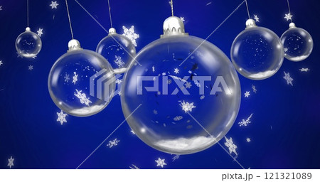 Image of baubles over snow falling on blue background Image of baubles over snow falling on blue background 121321089