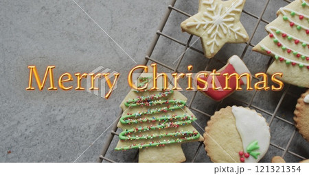 Merry christmas text in orange over decorated on christmas cookies Merry christmas text in orange over decorated on christmas cookies 121321354