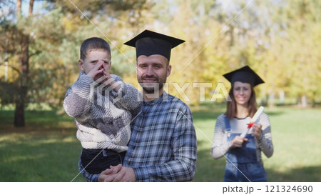 A joyful family comes together to celebrate graduation day in a stunning outdoor setting filled with love and happiness 121324690