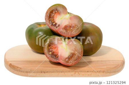 A bunch of ripe tomato of the Kumato variety with dark green and brownish glossy skin on an isolated background 121325294