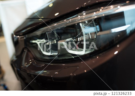 BMW car front lights, side view, brown paint, BMW showroom Wroclaw Poland, April 28, 2017 121326233