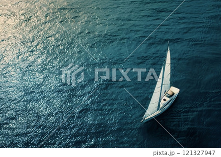 Sailboat sailing on calm blue ocean water 121327947