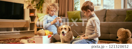 Banner. Children explore tools for health check-up with focus on understanding medicine basics, while dog observes, encouraging interactive learning. 121328652