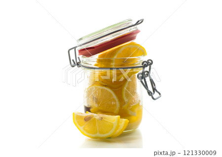 sliced lemons in sugar syrup in a glass jar, canned sliced lemons in sugar syrup in a glass jar, canned 121330009