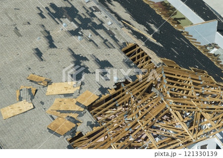Hurricane Ian destroyed house roof and walls in Florida residential area. Natural disaster and its consequences Hurricane Ian destroyed house roof and walls in Florida residential area. Natural disaster and its consequences 121330139