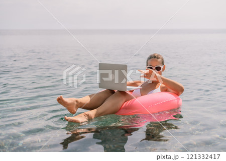 Freelance close up woman hands writing on computer. Well looking middle aged woman typing on laptop keyboard outdoors with beautiful sea view. 121332417