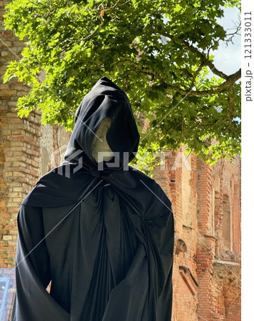 Mysterious Hooded Figure in Sunlit Ruins Mysterious Hooded Figure in Sunlit Ruins 121333011