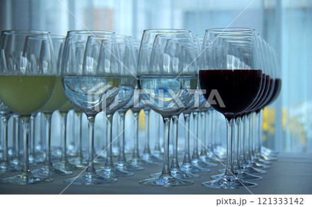 Wedding guest table with glasses filled with white and red wine Wedding guest table with glasses filled with white and red wine 121333142
