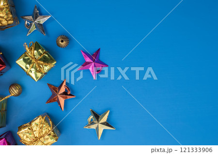 Colorful gift boxes and stars with gold decorations on a blue background 121333906