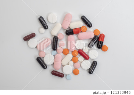 Multicolored pills and capsules on white background, top view Multicolored pills and capsules on white background, top view 121333946