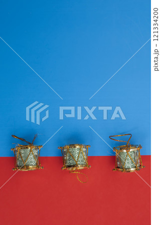 Traditional Christmas decorative drums on a bright blue and red background 121334200