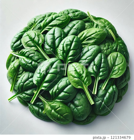 A close-up of a large, dense bunch of fresh spinach leaves with a vibrant green color, glossy texture, and prominent veins, showcasing their freshness and nutrient richness 121334679