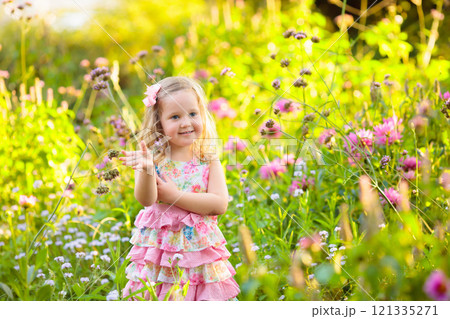 Little girl in flower garden 121335271