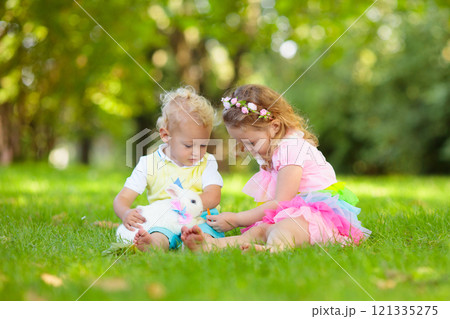 Kids playing with pet rabbit Kids playing with pet rabbit 121335275