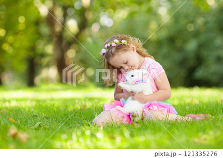 Kids playing with pet rabbit Kids playing with pet rabbit 121335276