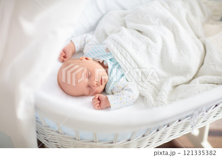 Cute newborn baby in white bed 121335382