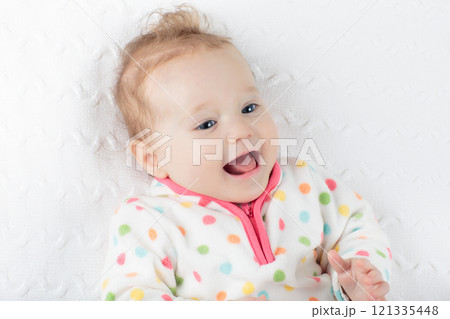 Little baby girl on colorful blanket 121335448
