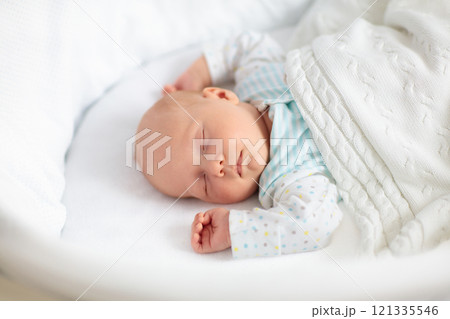 Cute newborn baby in white bed Cute newborn baby in white bed 121335546