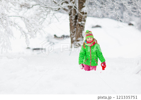 Girl on sled ride. Child sledding. Kid on sledge 121335751