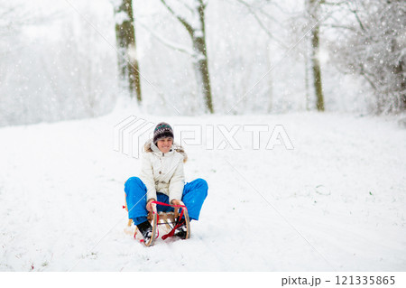 Kids play in snow in winter park Kids play in snow in winter park 121335865