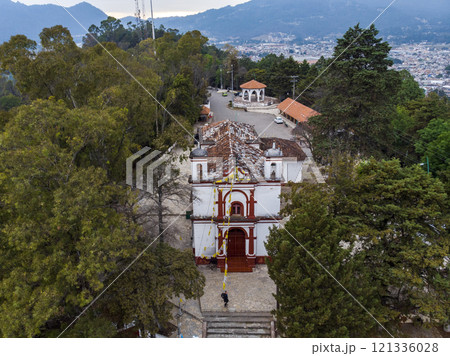 Aerial Drone shot of Church Iglesia de San Cristobalito on the mountain in San Cristobal de Las Casas, Chiapas, Mexico 121336028
