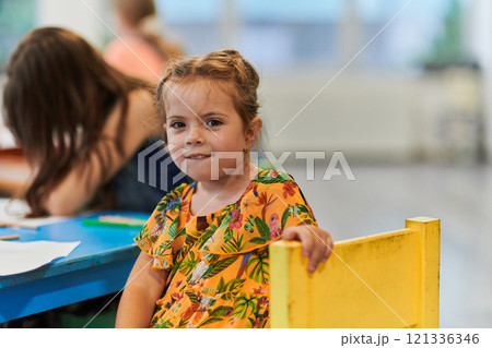 Creative kids sitting in a preschool institution, draw and have fun while they get an education 121336346