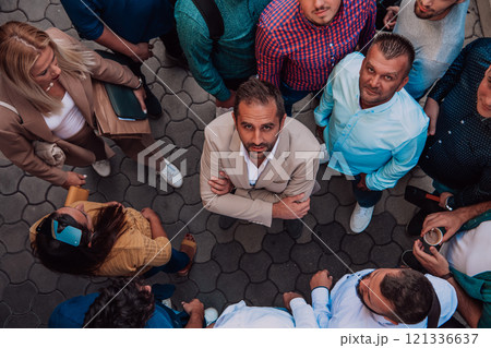 A top view photo of group of businessmen and colleagues standing together, looking towards the camera, symbolizing unity and teamwork. 121336637