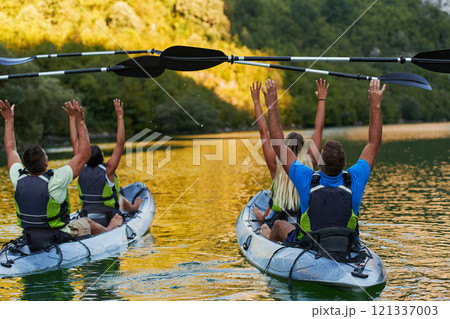 A group of friends enjoying having fun and kayaking while exploring the calm river, surrounding forest and large natural river canyons 121337003