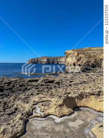 Fantastic views of rocky coast on a sunny day with blue sky at Gozo 121337335