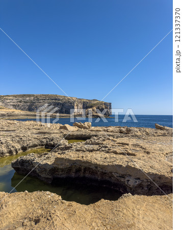Fantastic views of rocky coast on a sunny day with blue sky at Gozo Fantastic views of rocky coast on a sunny day with blue sky at Gozo 121337370