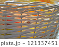 Wicker basket texture. Fruits can be seen behind the wall of the basket. High quality photo 121337451